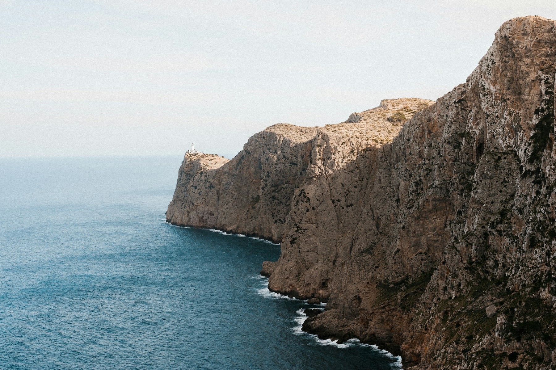 Pale limestone cliffs above the blue Mediterranean water on the coast of Mallorca