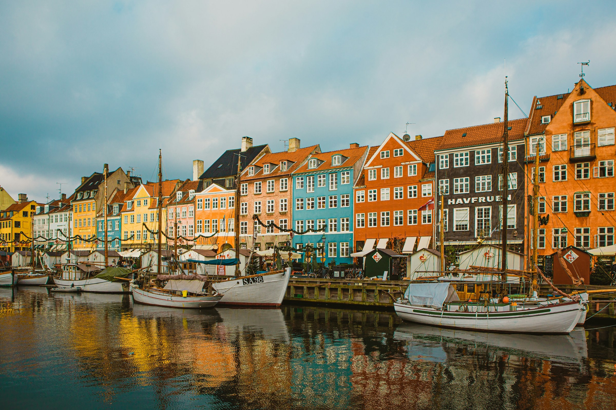 Boats beside colorful buildings along Copenhagen's Nyhavn canal